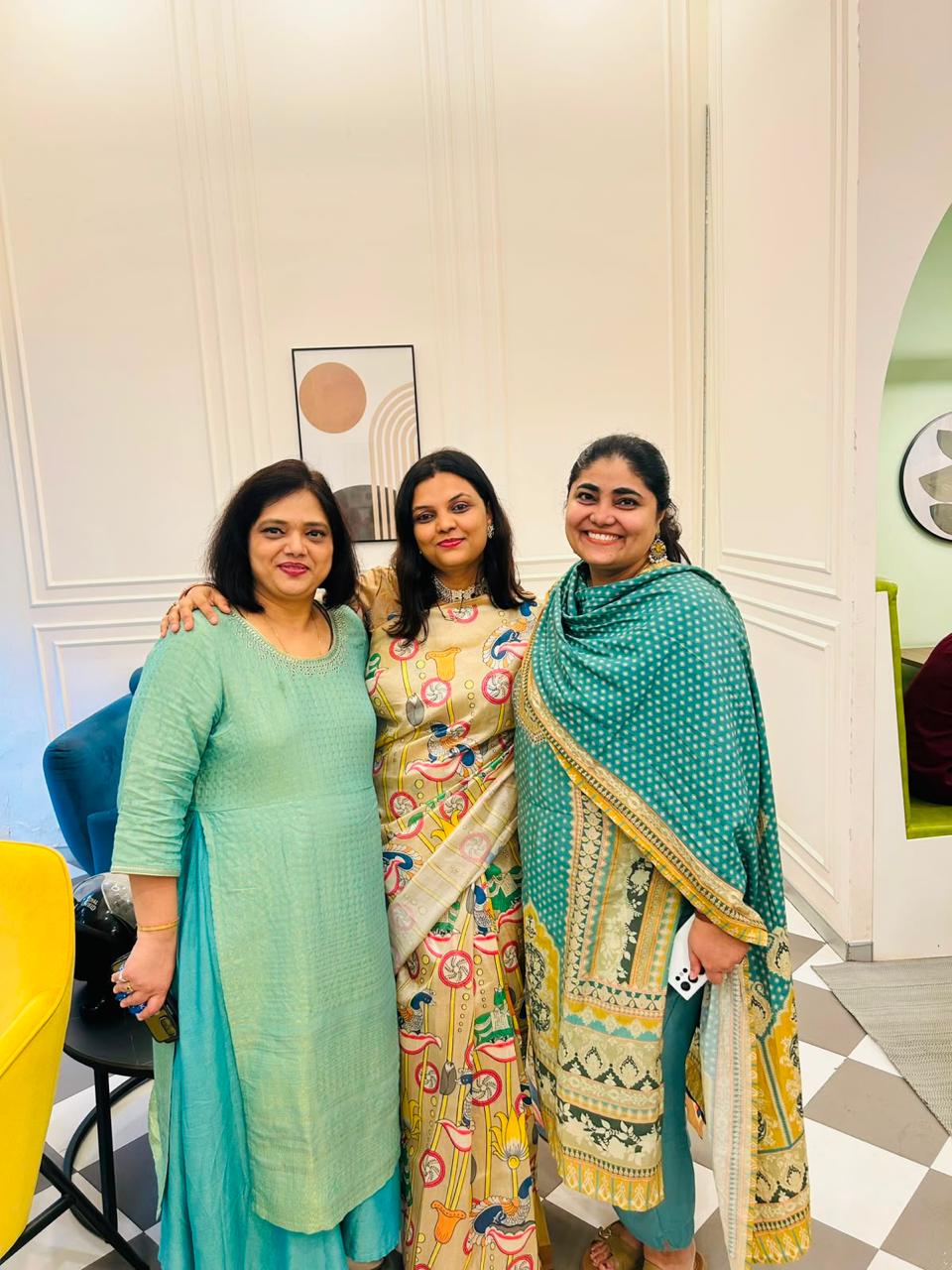 Three colleagues dressed up for a team celebration