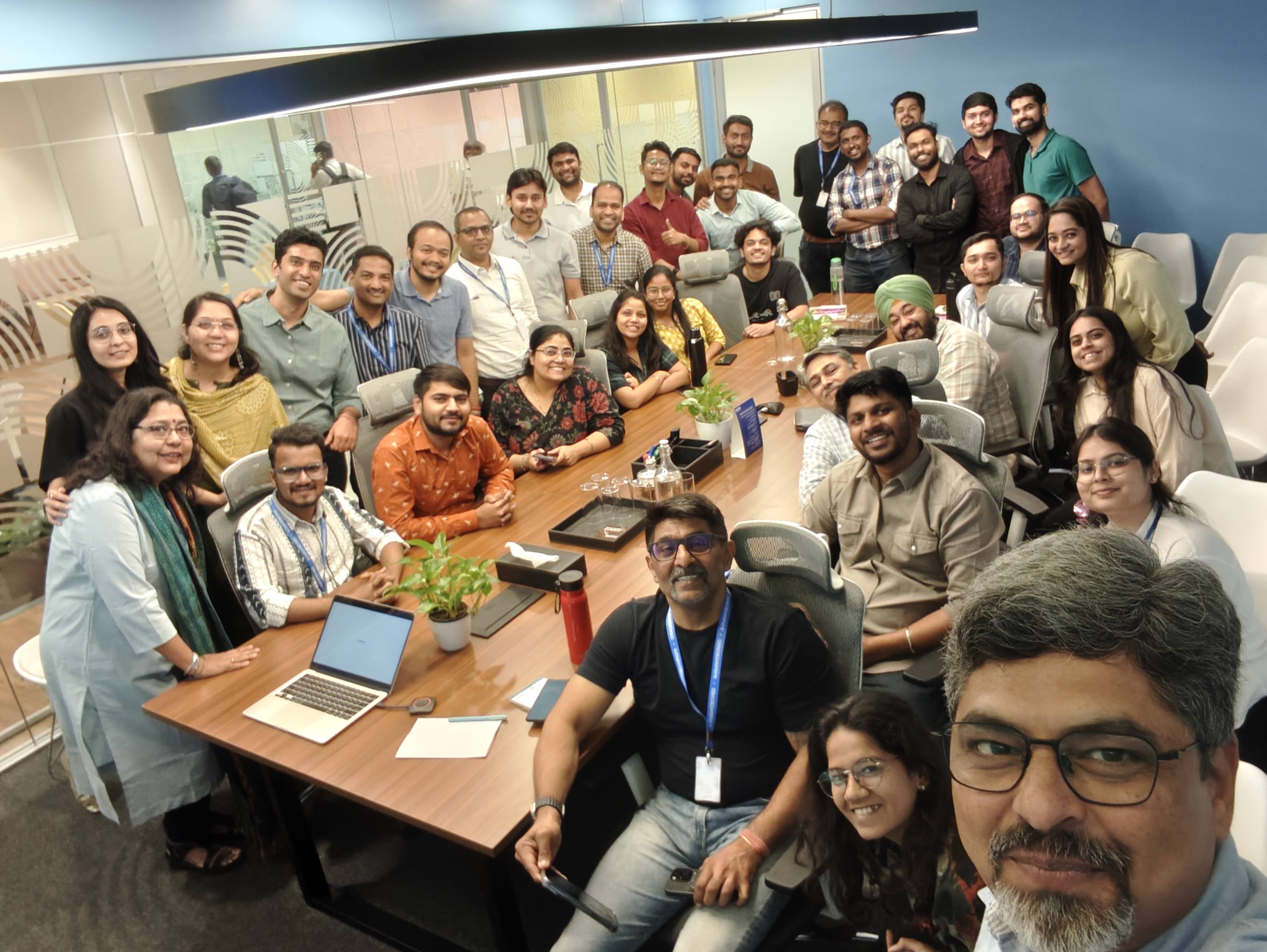 The apibanking team gathered around the conference table for a group selfie